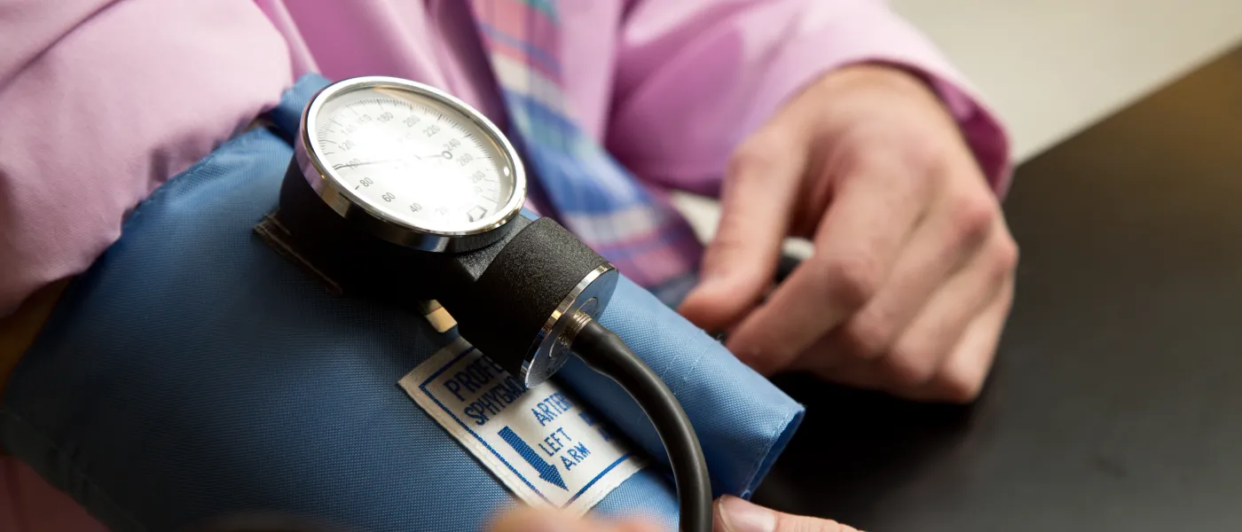 A blood pressure cuff on a patient's arm