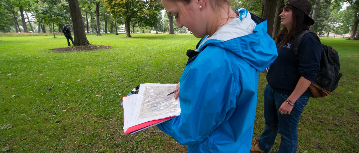 U N E Environmental Studies student looks at a map