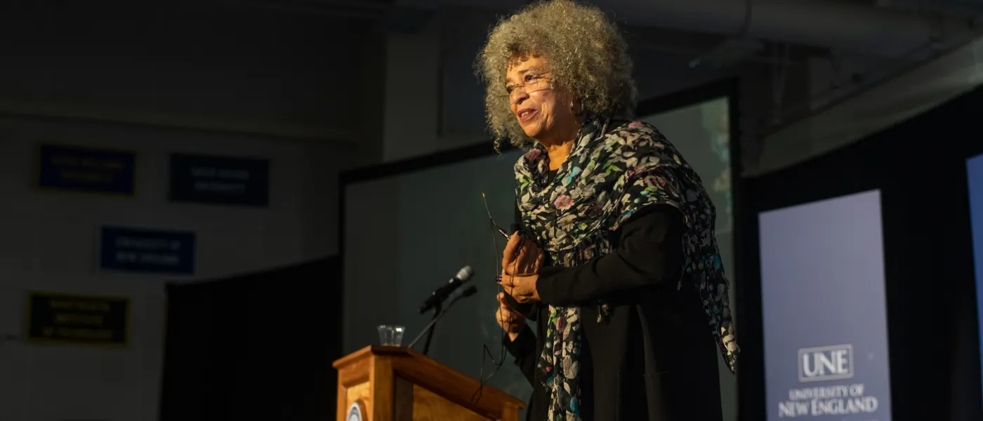 Side view of Angela Davis addressing the crowd from the podium