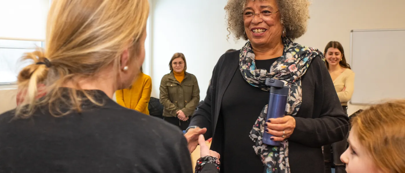 Angela Davis greets attendees after her speech