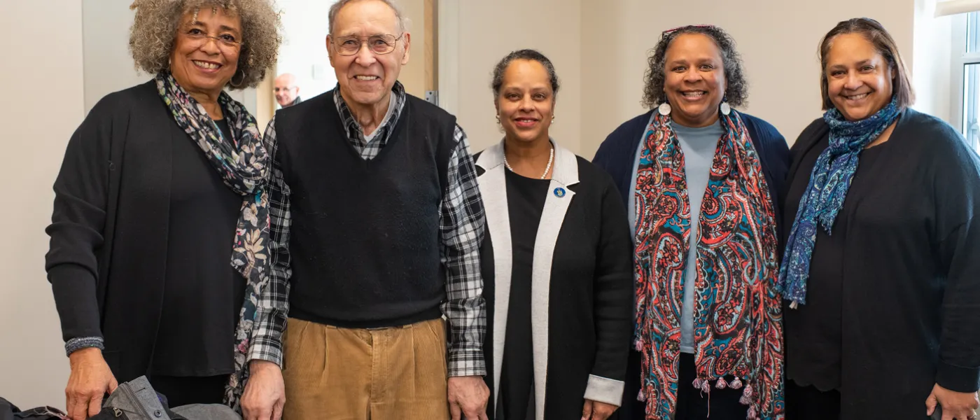 Angela Davis poses with U N E employees