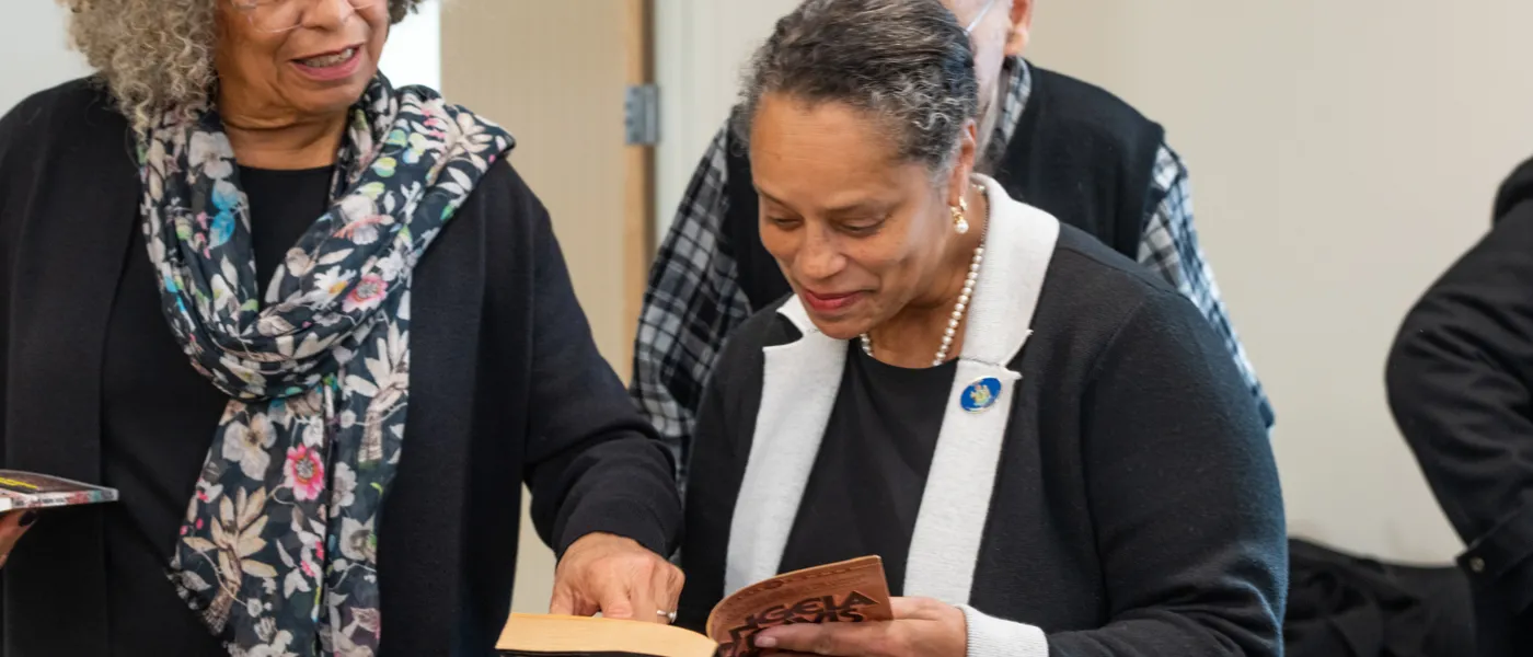 Angela Davis shows excerpts from her book to a U N E employee