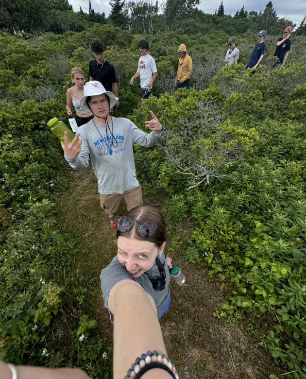 A group of students take a selfie on a hike on Peaks Island