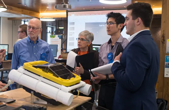 A U N E student presenting to judges at the Student Innovation Challenge event