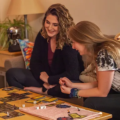 Two UNE students playing a game in their dorm room