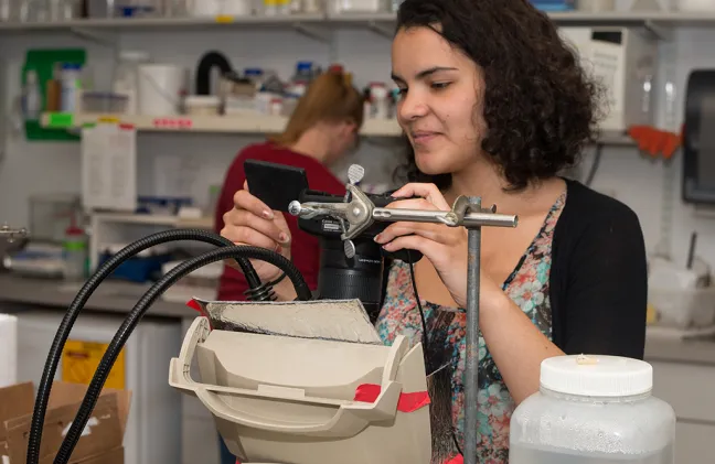 A student working with tools in a lab