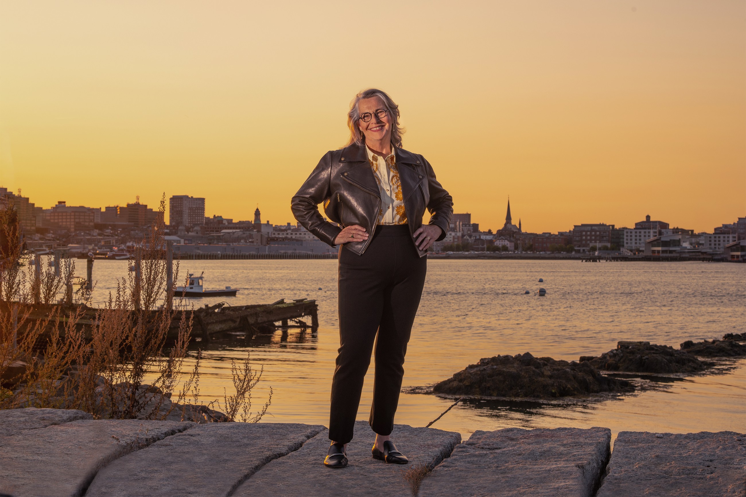 Karen Houseknecht standing infront of Casco Bay and the city of Portland