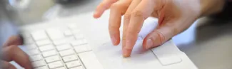 Hands on a laptop