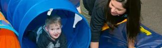 An occupational therapy student use play therapy to work with a child