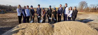 UNE leadership dig into the earth at the groundbreaking ceremony for the Harold and Bibby Center for Health Sciences on Tuesday, Nov. 29, 2022