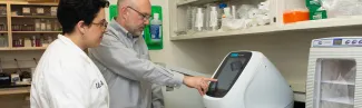 A U N E student works in a faculty research lab