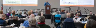 Tom Meuser speaks to an audience at a Legacy Scholars Breakfast for the Center of Excellence in Aging and Health