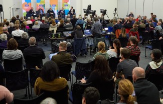 A large crowd gathers to watch a panel of speakers discuss the election in the Harold Alfond Forum room 283