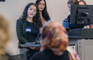 A group of students gives a slideshow presentation