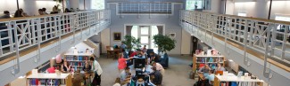 A view from the catwalk in the Portland campus library of students studying in the library