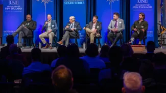 Panelists speak onstage in Innovation Hall