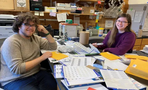 UNE student Brooke Parks sits with MDI Biological Laboratory independent study student, Adam Feher.