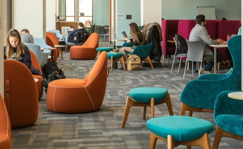 Several students studying in the Commons