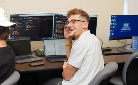 A business student watches a class lecture