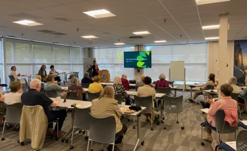 A room of workshop attendees views a presentation