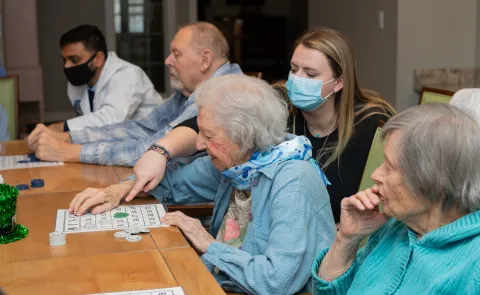 UNE health professions students play bingo with seniors at an assisted living facility