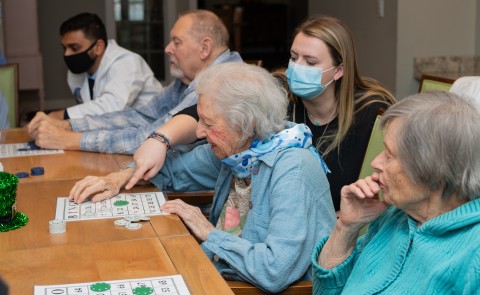 UNE health professions students play bingo with seniors at an assisted living facility
