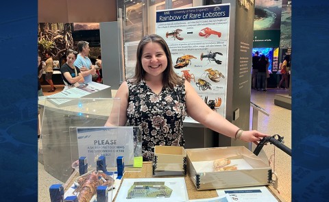 A UNE researcher poses for a photo with her research materials at the Smithsonian natural history museum