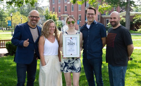 Members of UNE's Communications Office and Redfin Solutions pose with their 2024 Webby Awards