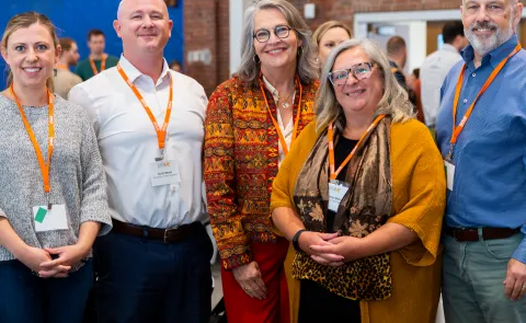 A group of UNE researchers and administrators pose for a photo