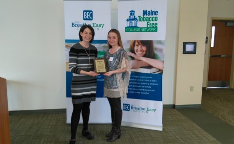 Cat Martins, UNE benefits and disability specialist, accepts the award