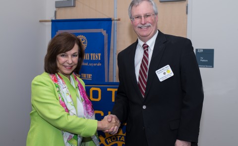 UNE President Danielle Ripich greets Bill Kany, president of the Biddeford-Saco Rotary Club.