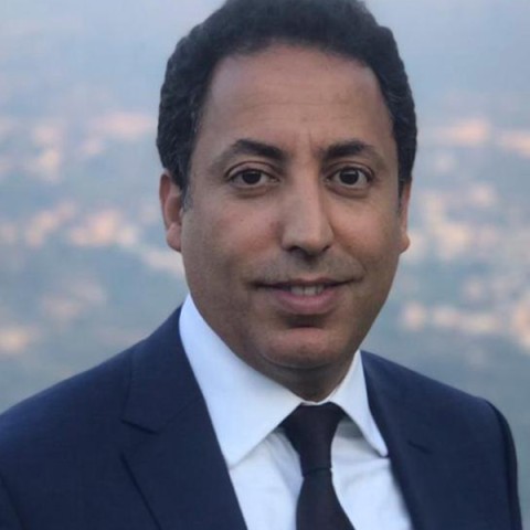 Headshot of Younes Abouyoub against a blue backdrop