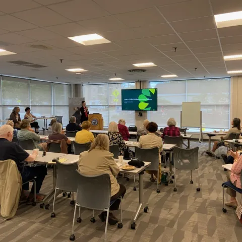 A room of workshop attendees views a presentation