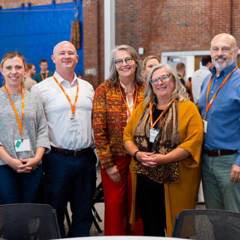 A group of UNE researchers and administrators pose for a photo