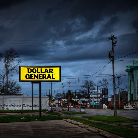 A Dollar General sign is illuminated against a dark sky