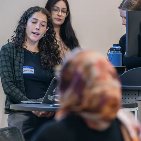 A group of students gives a slideshow presentation