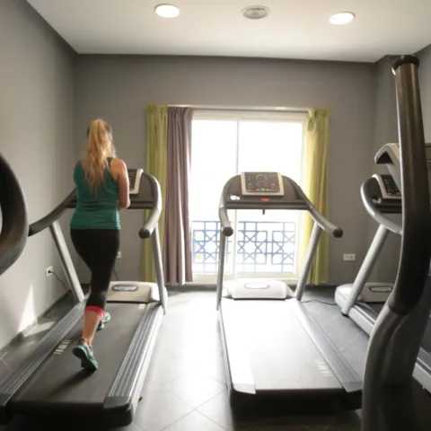 A woman runs on a treadmill